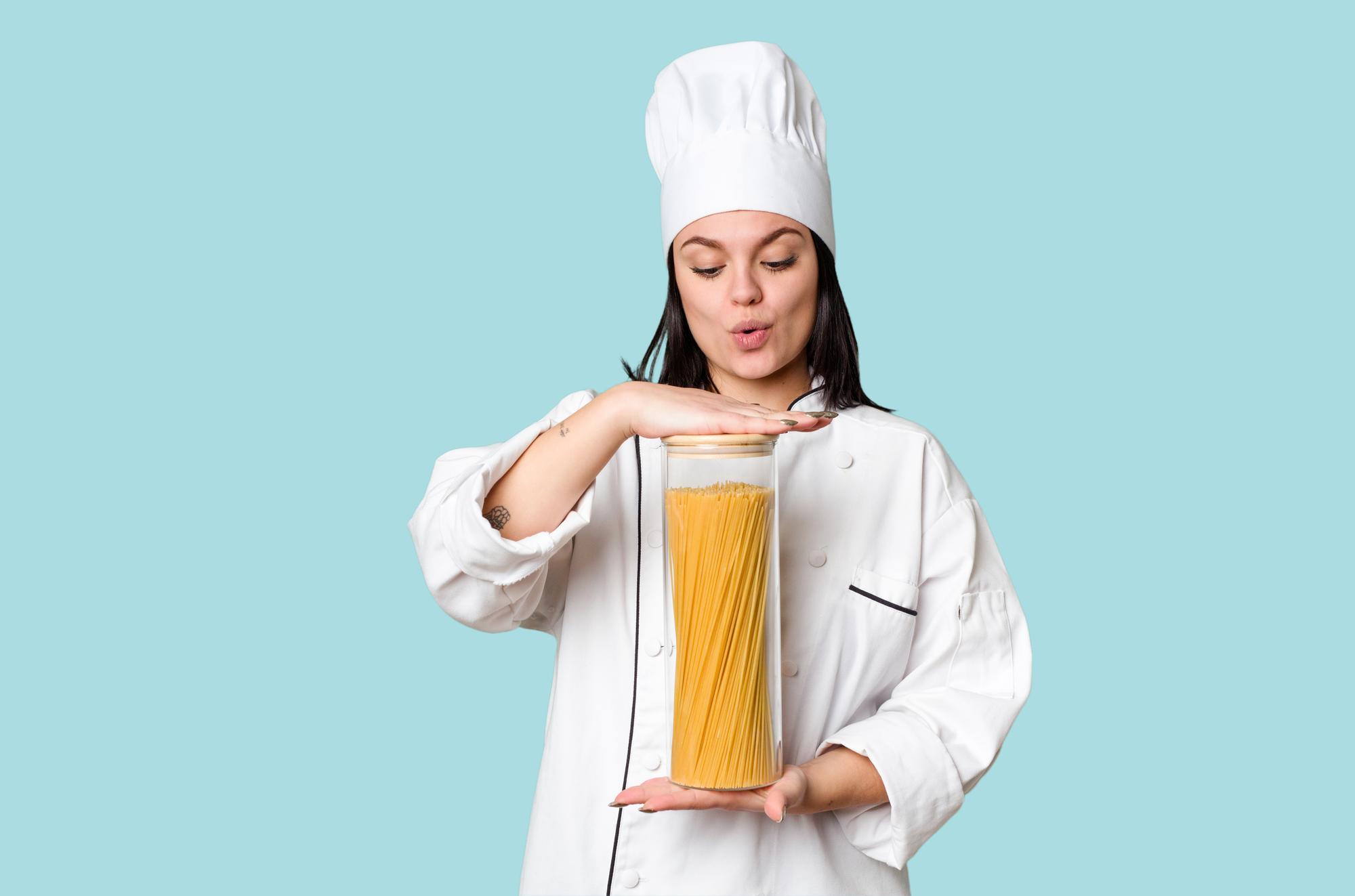 Student plating a pasta dish