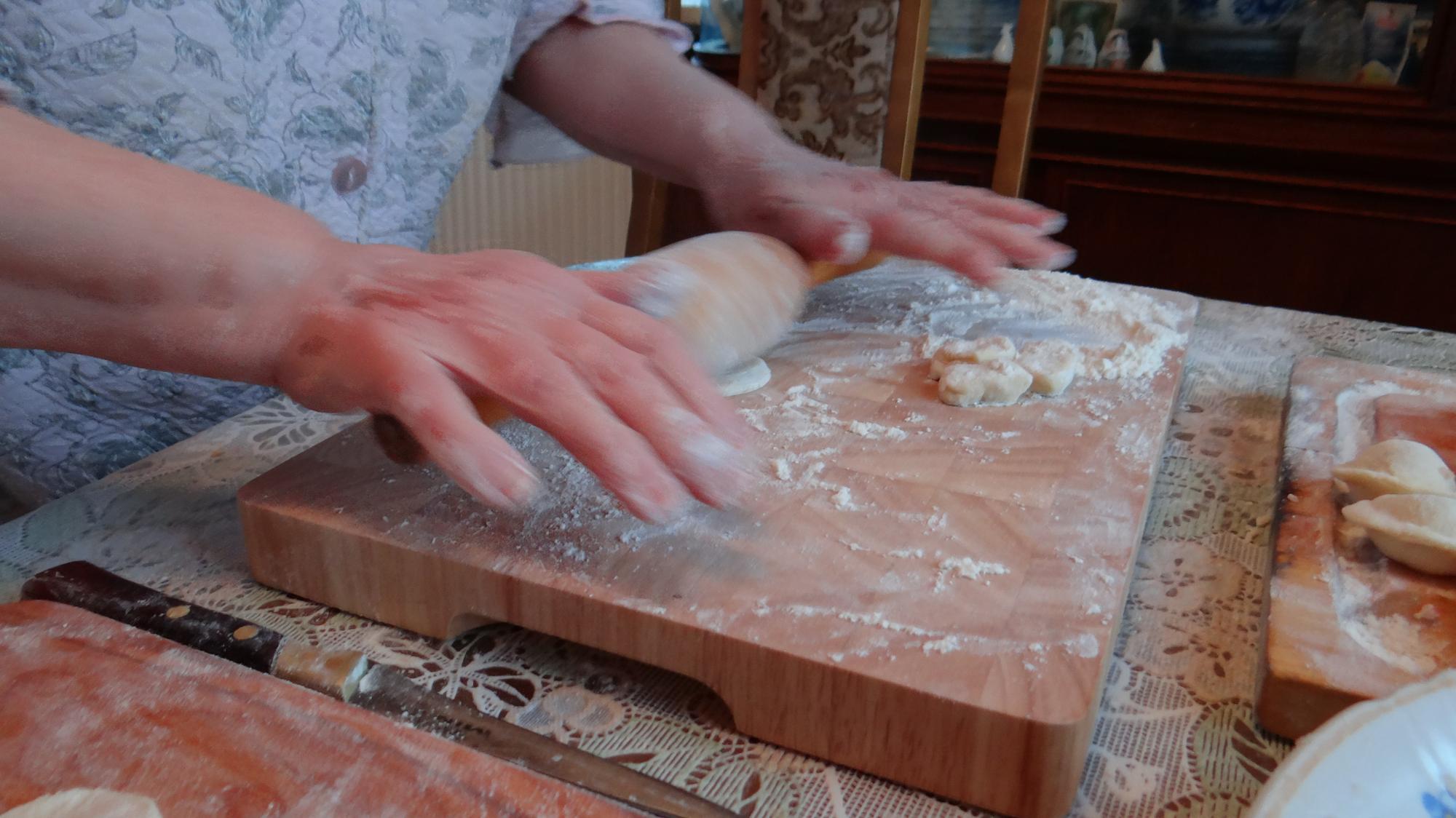 Close-up of hands kneading dough