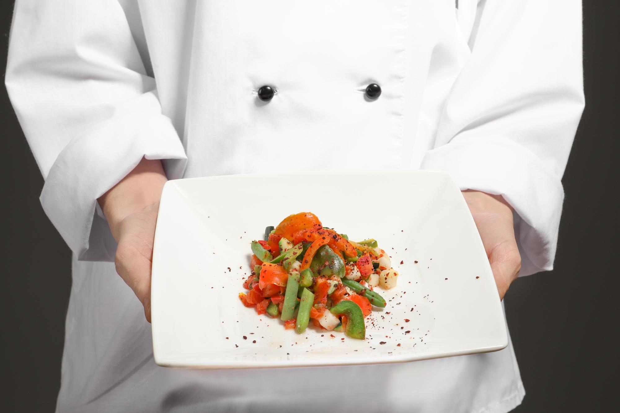 Chef showing plated dish during online lesson